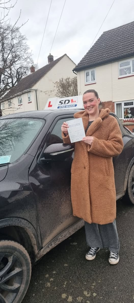 Smiling learner with driving instructor